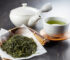 Japanese sencha tea leaves with teapot and cup on wooden table